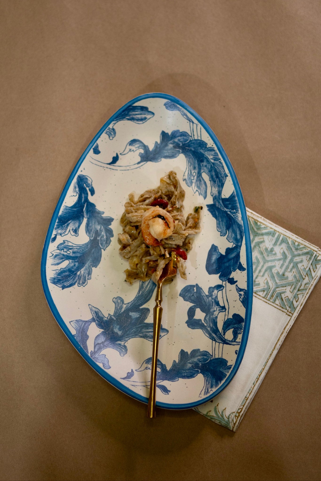 Decorative plate with blue floral patterns on a brown surface