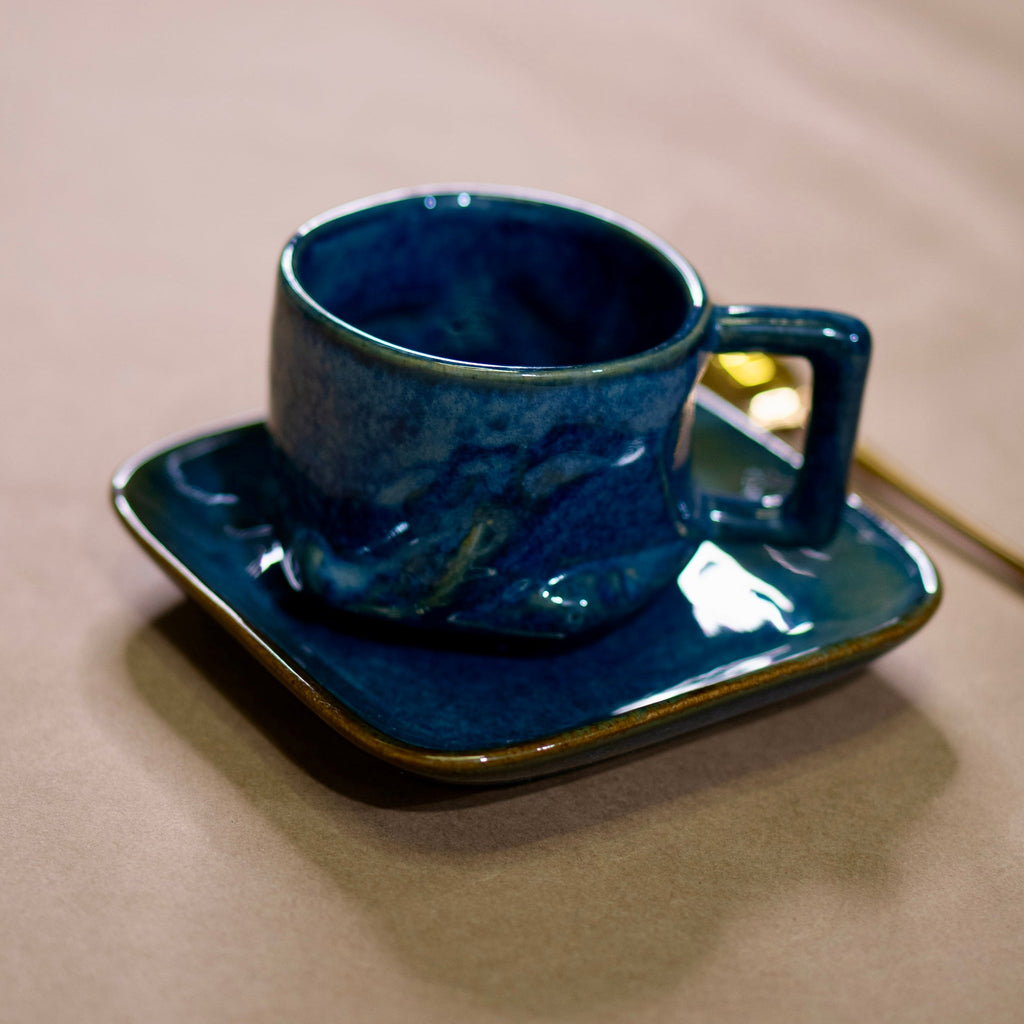 Blue mug on blue cookie and cake plate